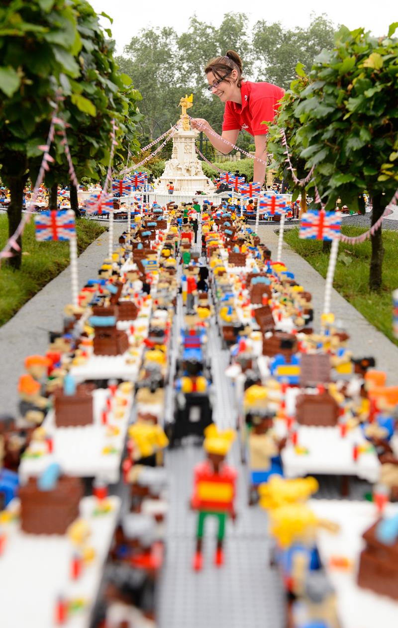 Model Maker Kat James puts the finishing touches to the miniature birthday party for Her Majesty The Queen at the LEGOLAND® Windsor Resort